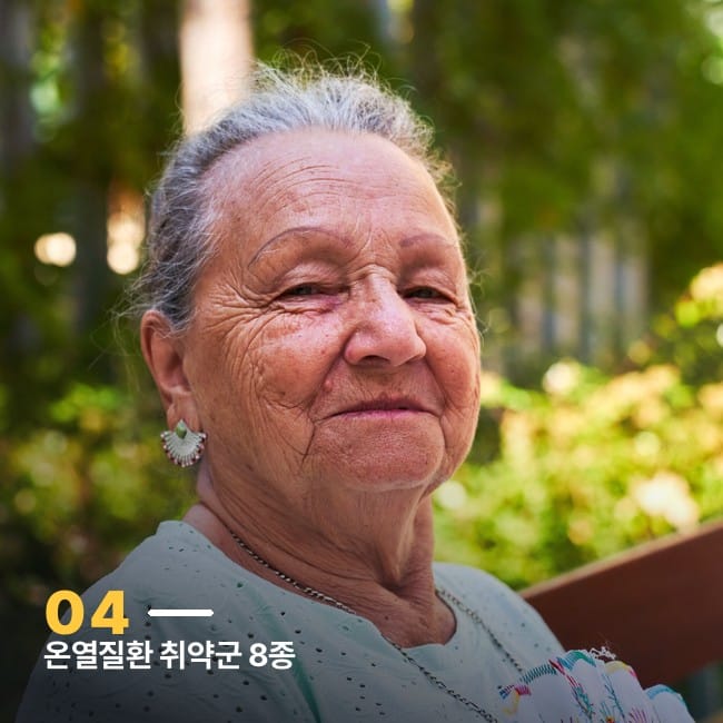 손부채를 들고 야외에 앉아 있는 어르신