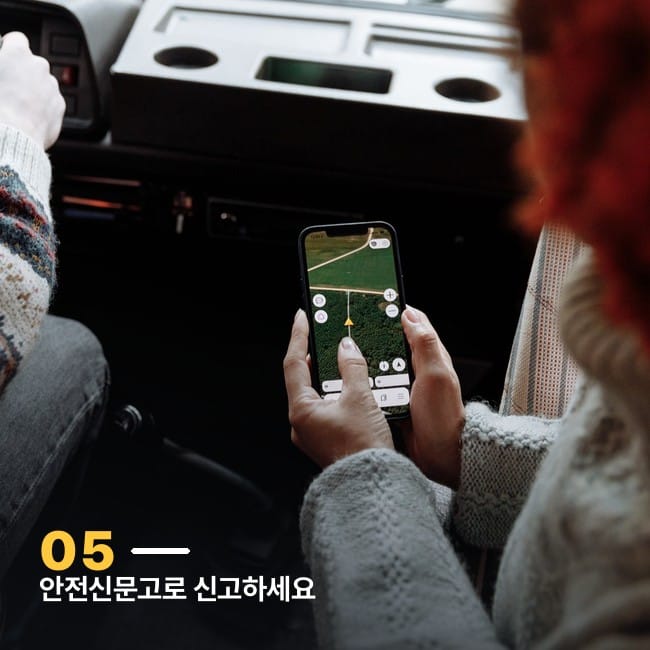 차 안에서 스마트폰 지도 앱을 보는 손